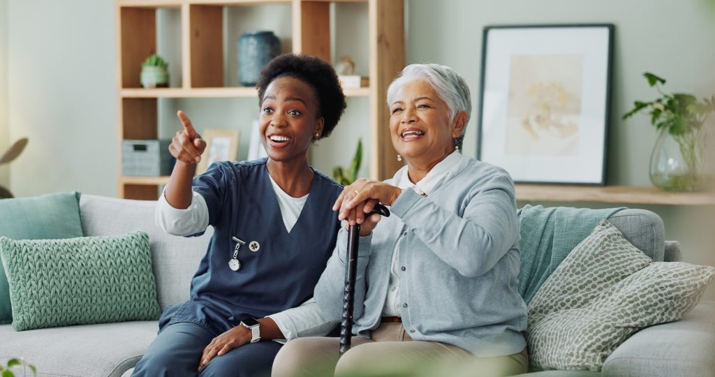 Nurse, mature woman and television with entertainment, retirement and elderly care for health. Seni